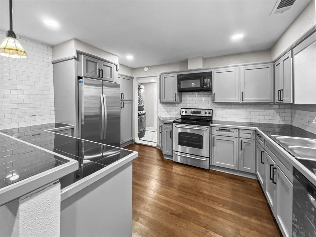 a kitchen with stainless steel appliances and wooden cabinets