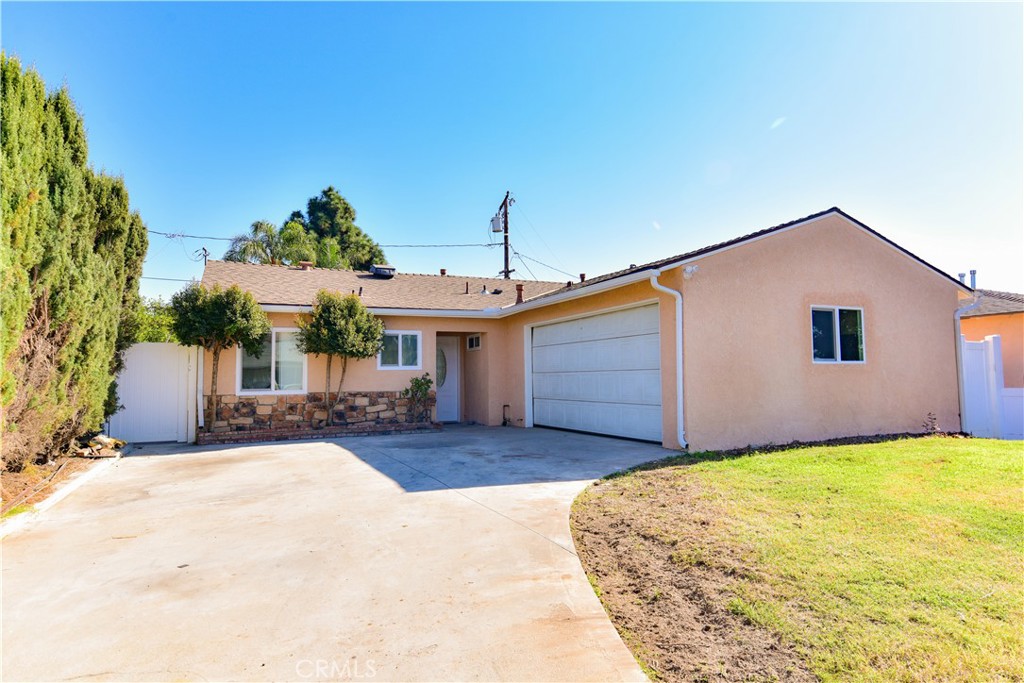 a view of a house with patio and a yard