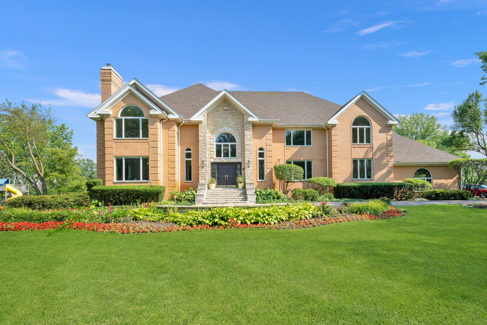 a front view of house with yard and green space