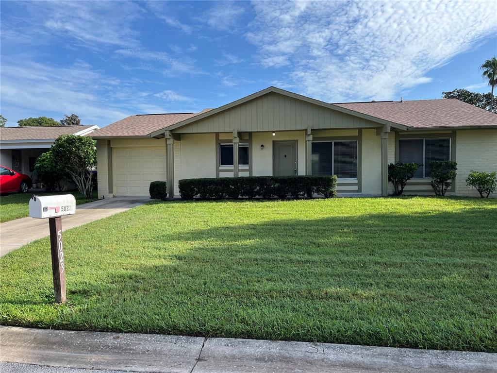 a front view of house with yard and green space