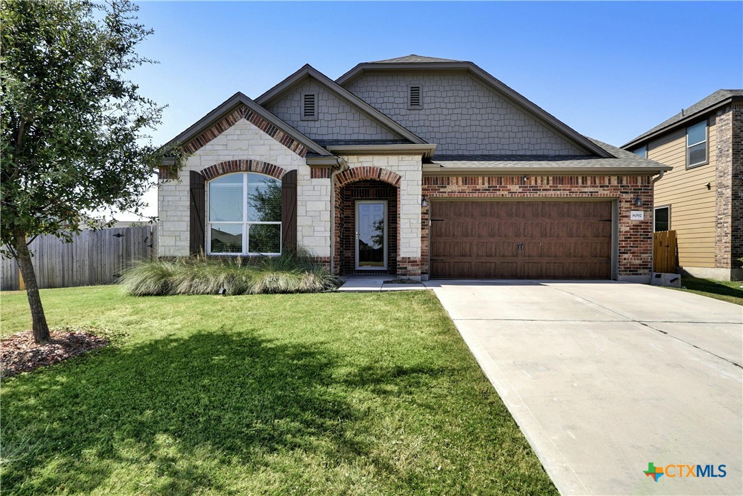 a front view of a house with a yard