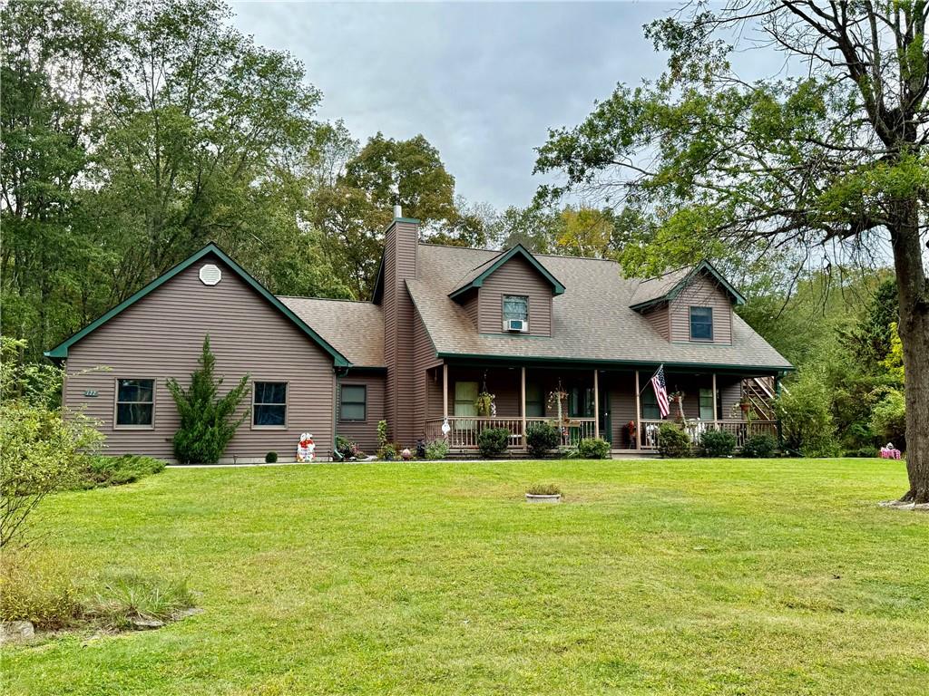 View of front of property featuring a front lawn and a porch