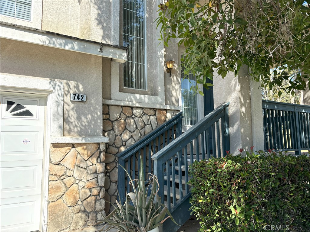 a view of a house with a tree in the background