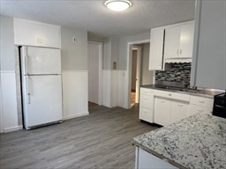 a kitchen with a sink stove and refrigerator