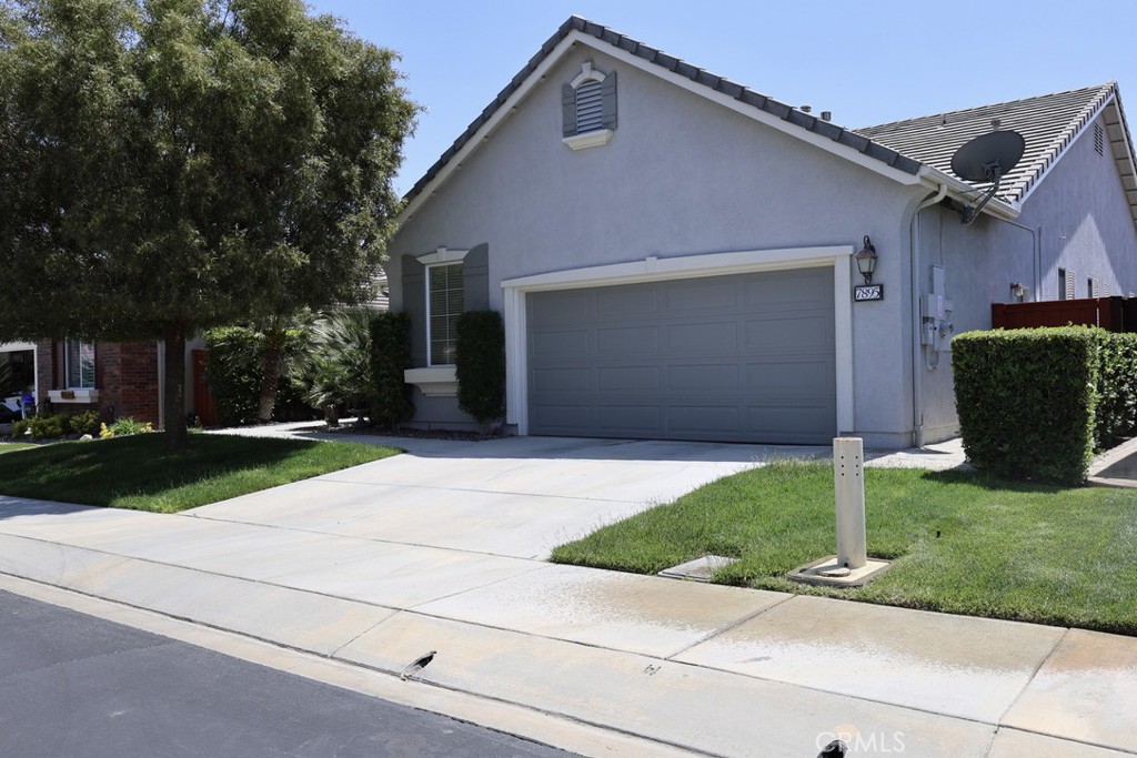 a front view of a house with a yard and a garage