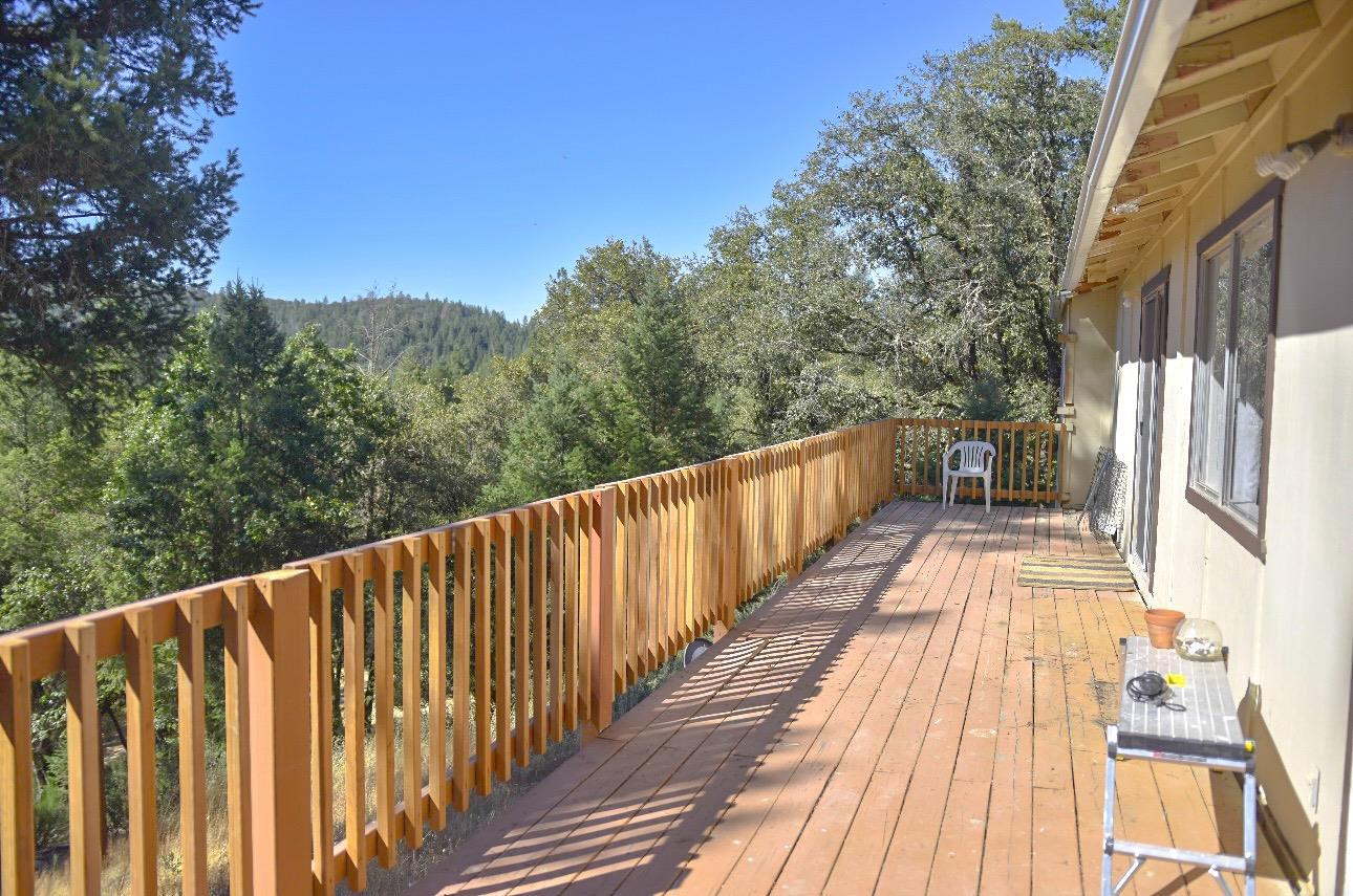 a view of balcony with wooden floor and fence