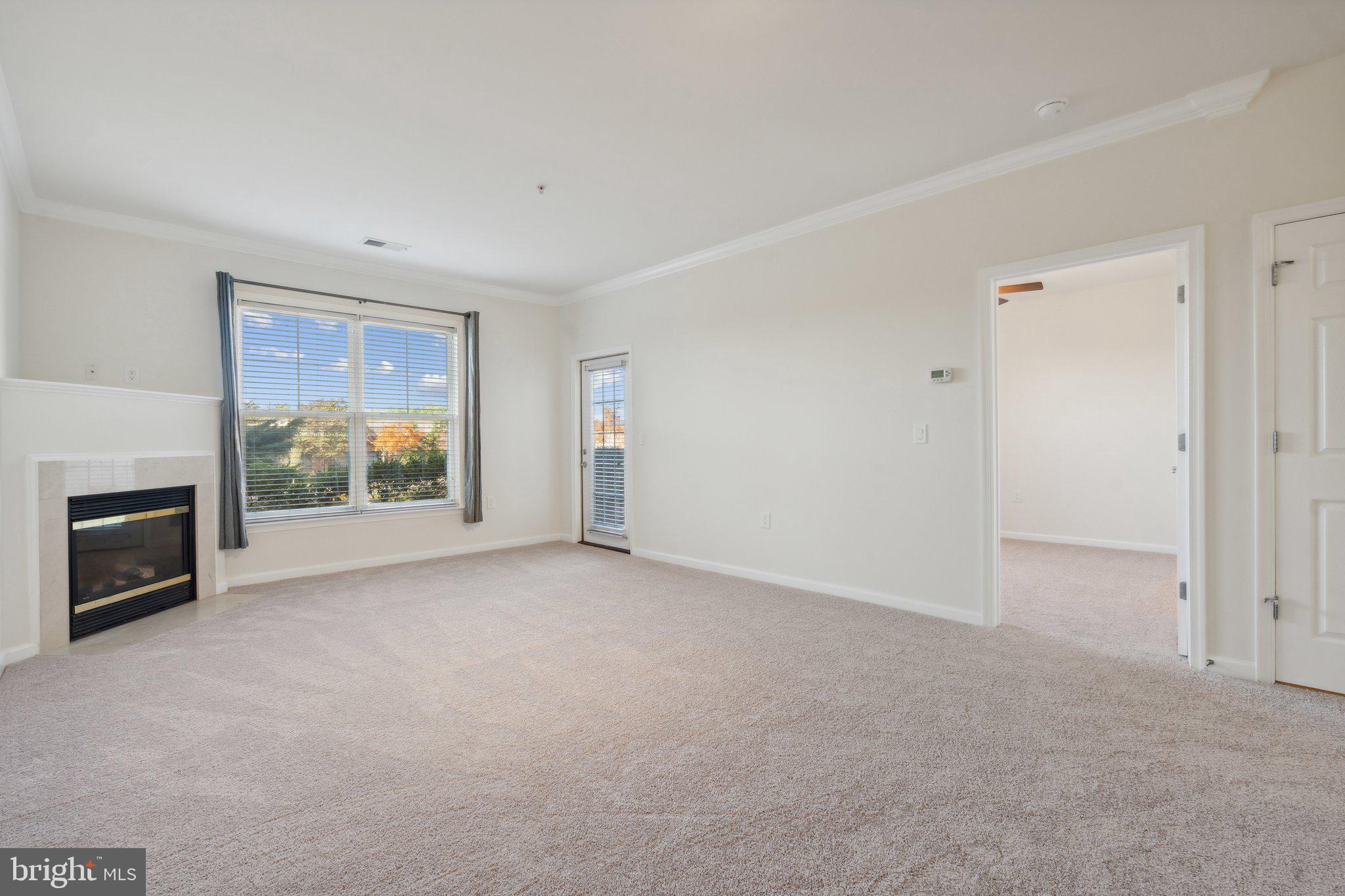 a view of empty room with furniture and fireplace