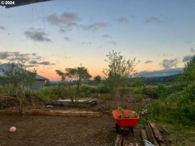 a backyard of a house with table and chairs