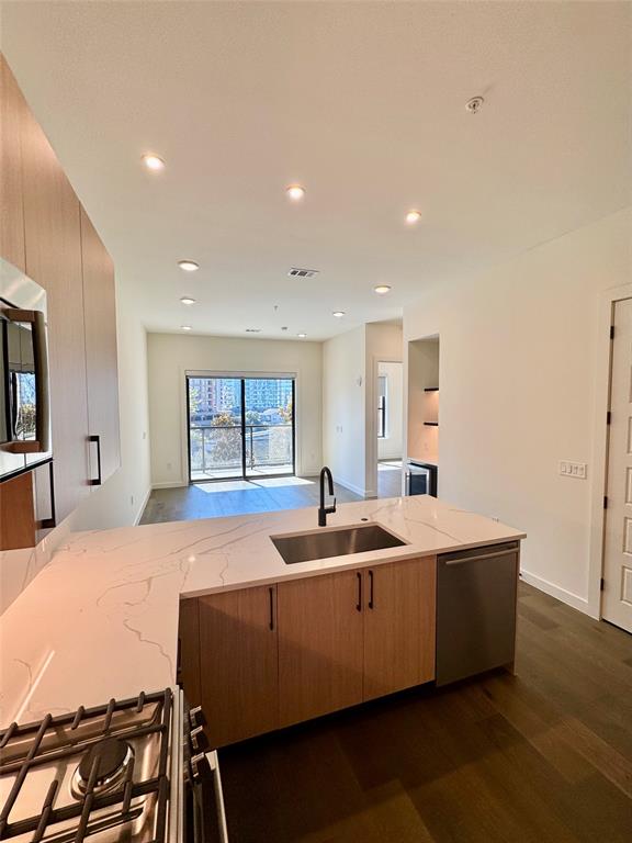 a living room with stainless steel appliances kitchen island granite countertop furniture and a large window