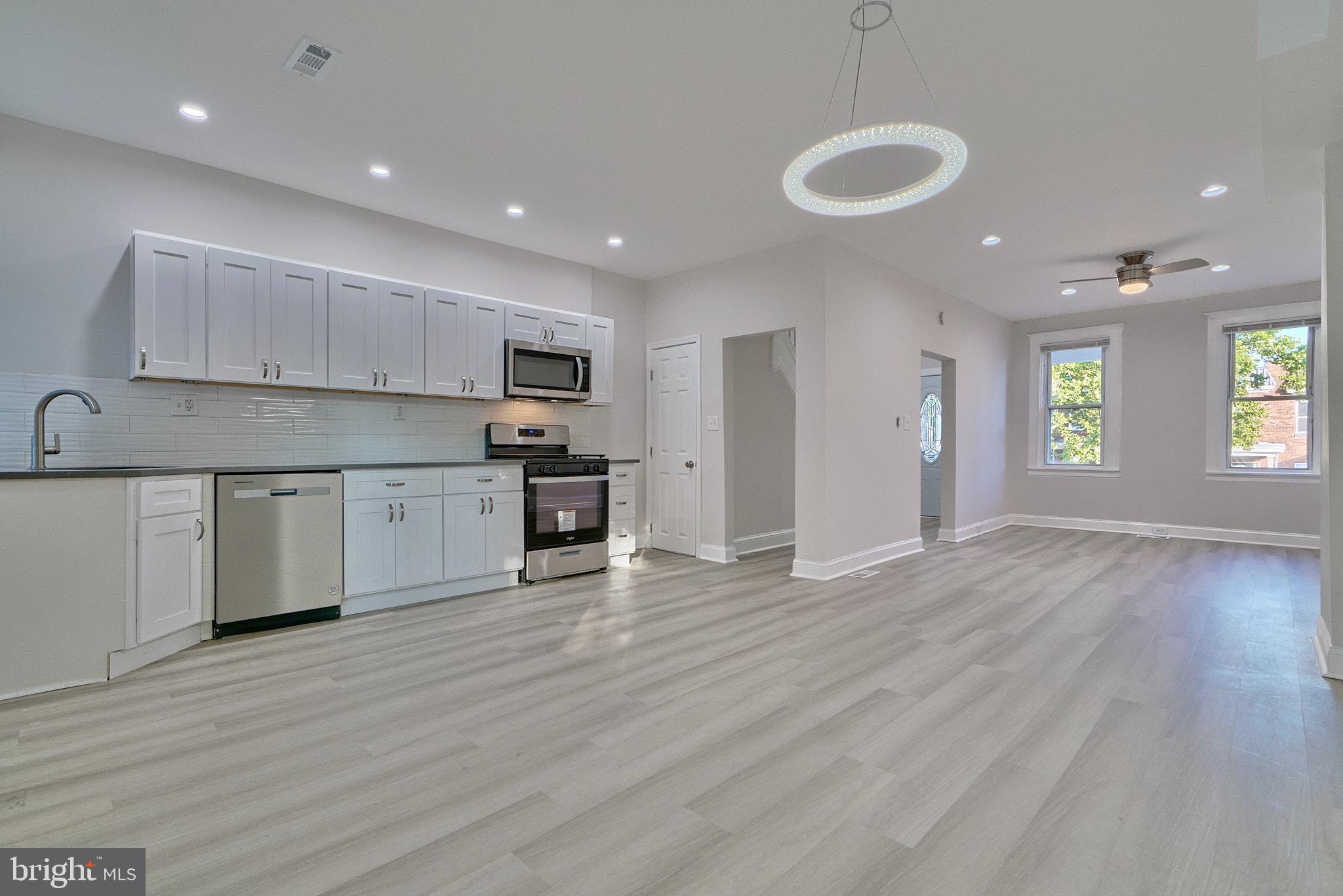 a view of kitchen with wooden floor and window