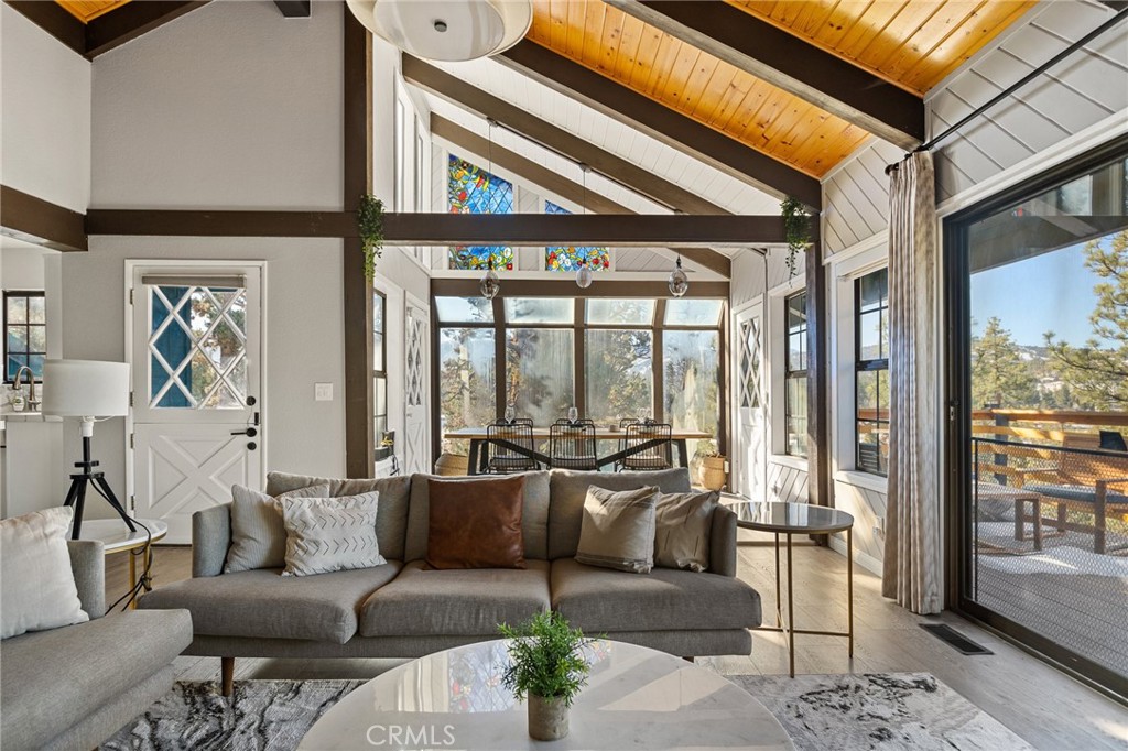 a living room with furniture and a floor to ceiling window