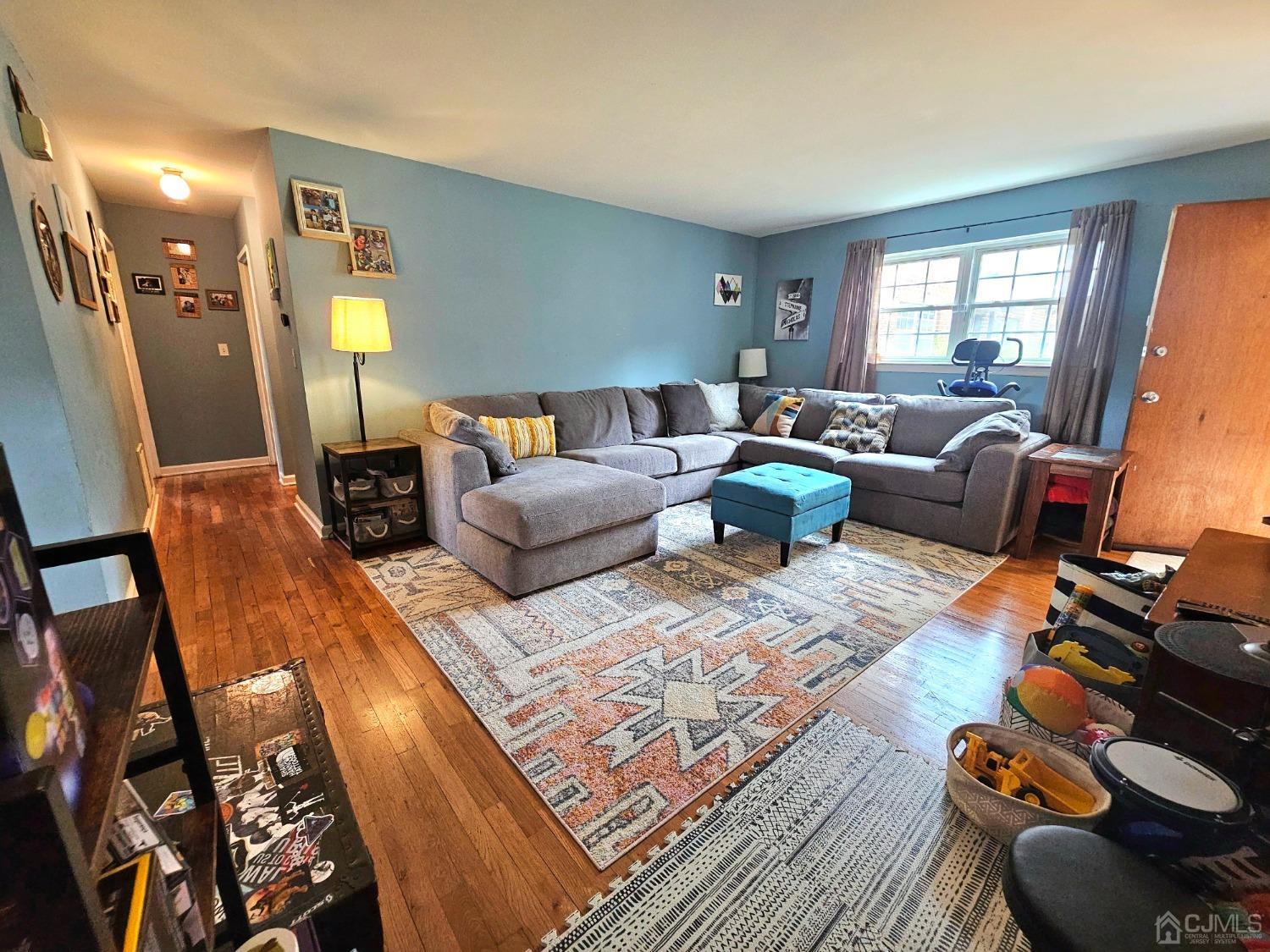 a living room with furniture fireplace and a window