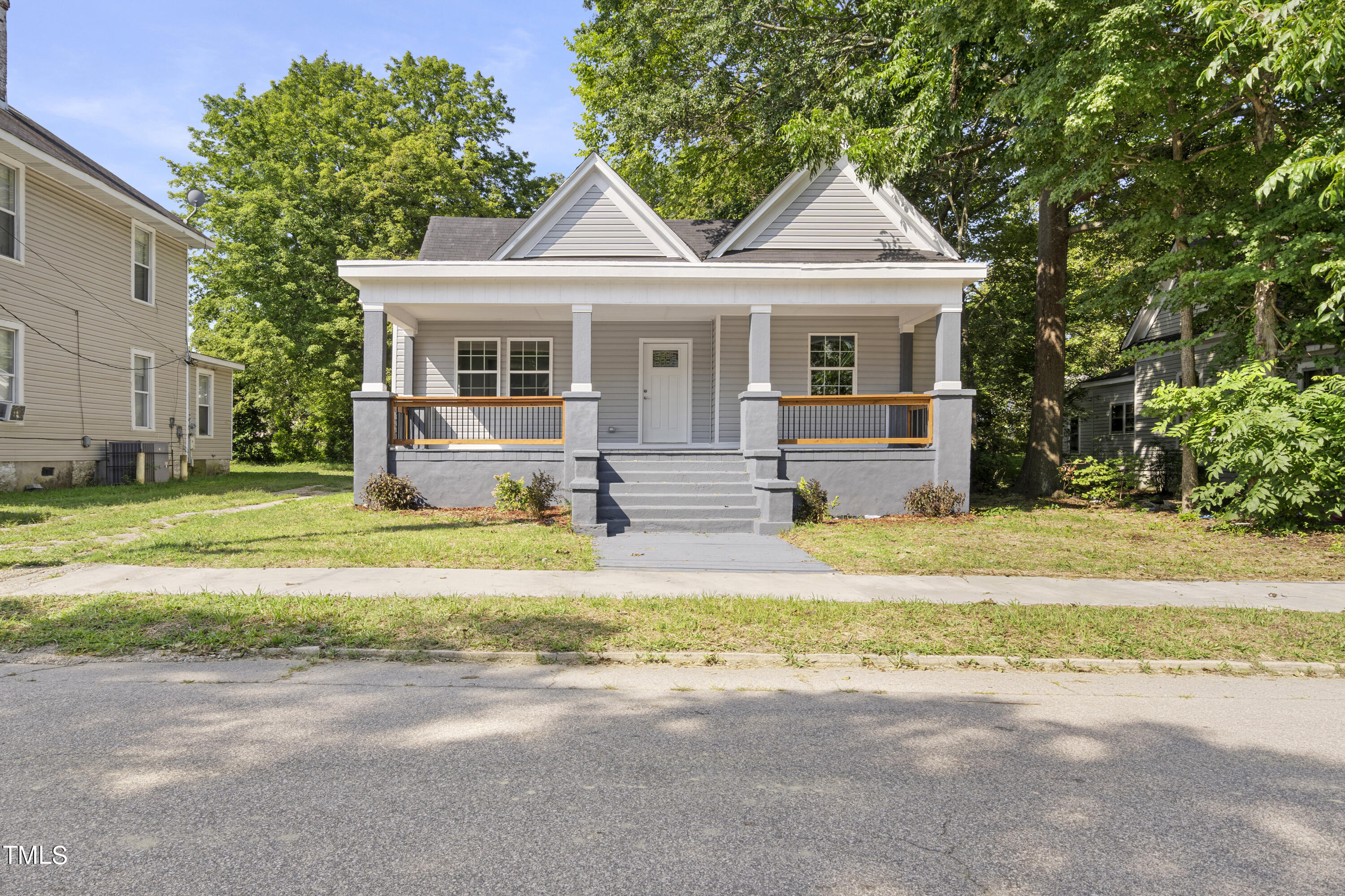 a front view of a house with a yard outdoor seating and garage