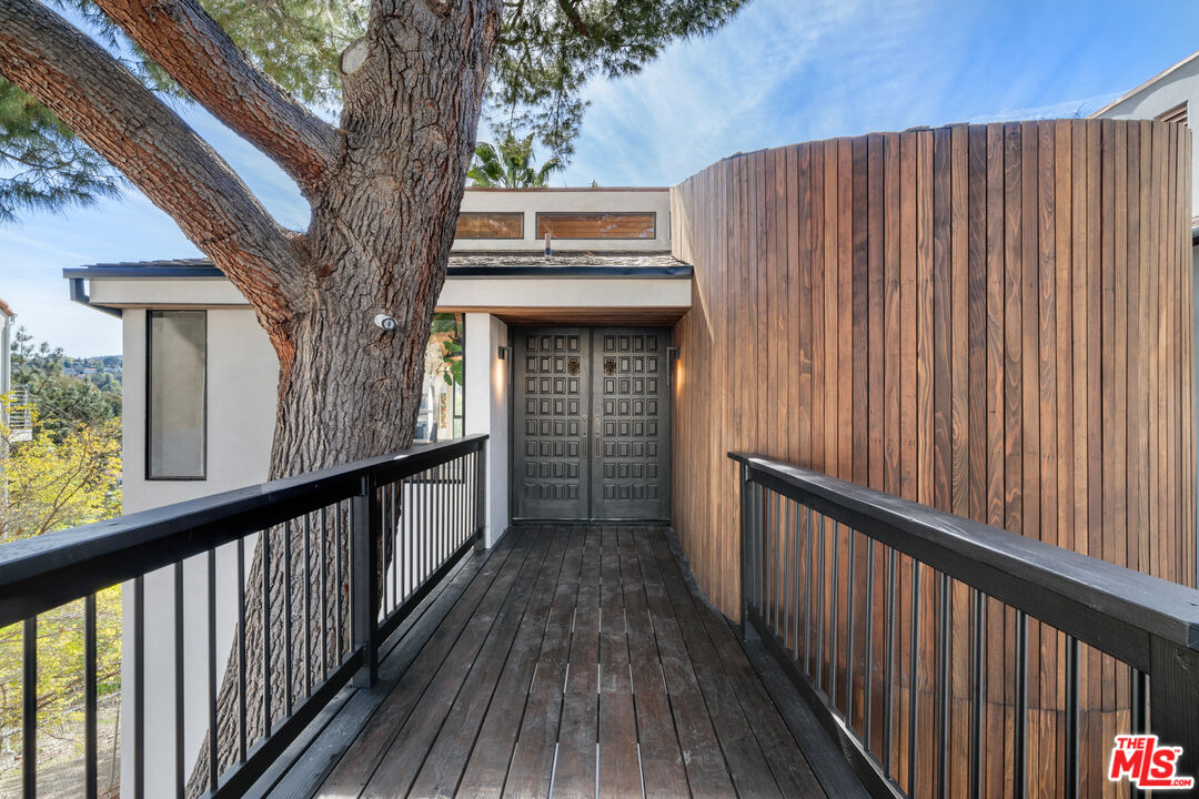 a view of balcony with wooden floor and fence