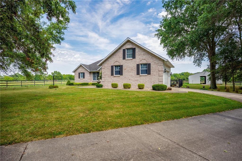 a front view of house with yard and green space