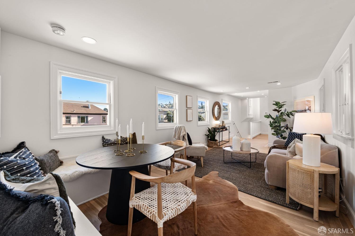 a living room with furniture a wooden floor and a table