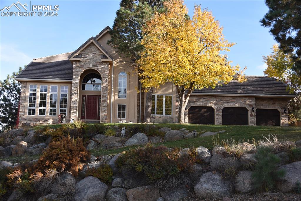 a front view of a house with a garden