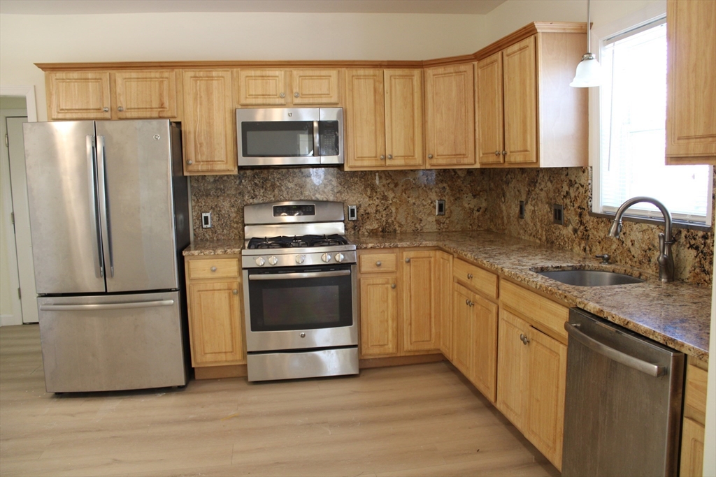 a kitchen with a refrigerator stove and microwave