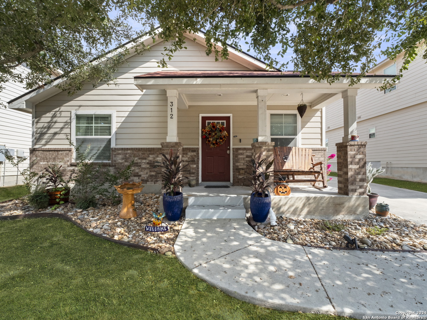 a front view of a house with a yard and outdoor seating