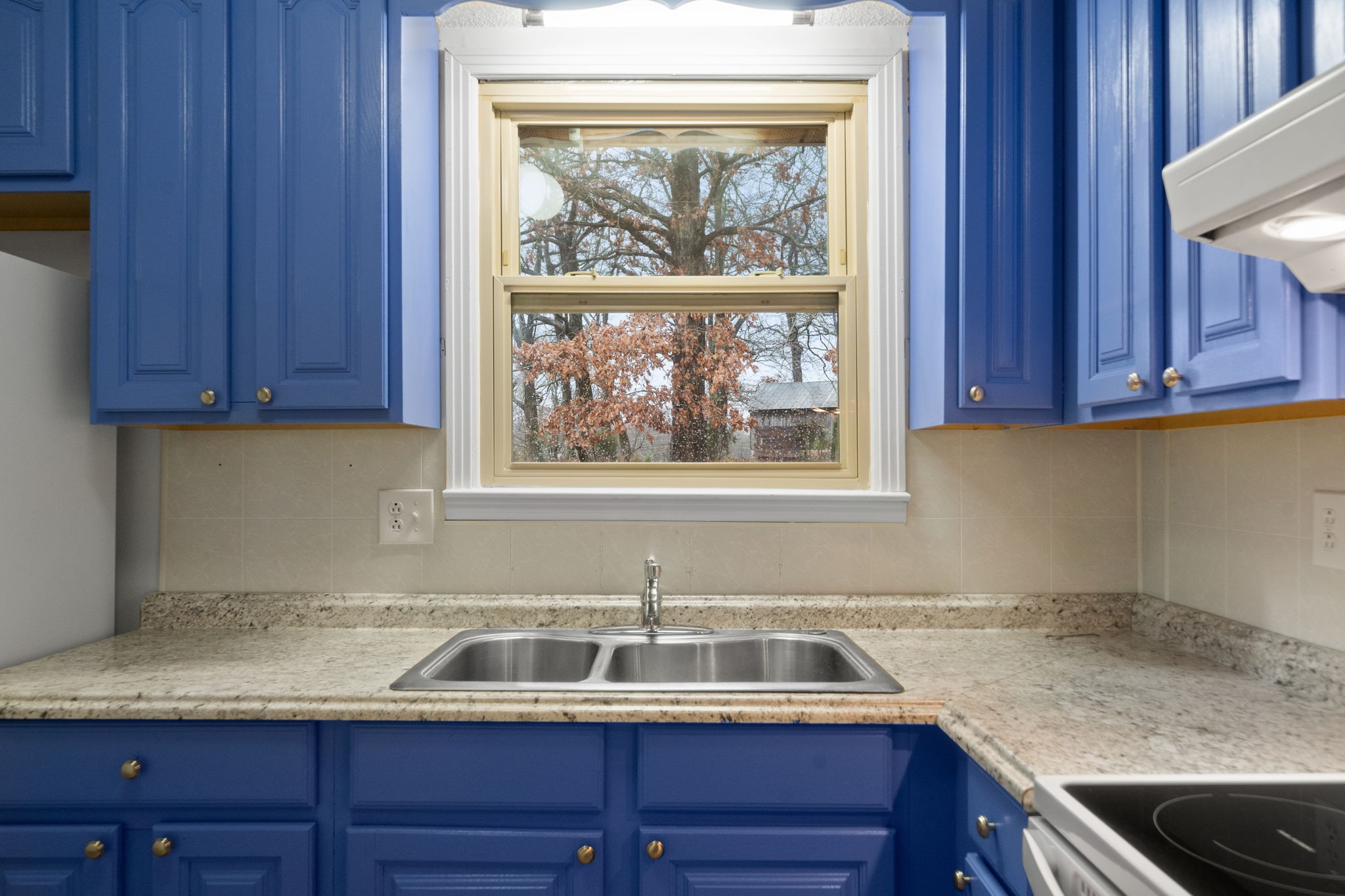 a kitchen with a sink and a window