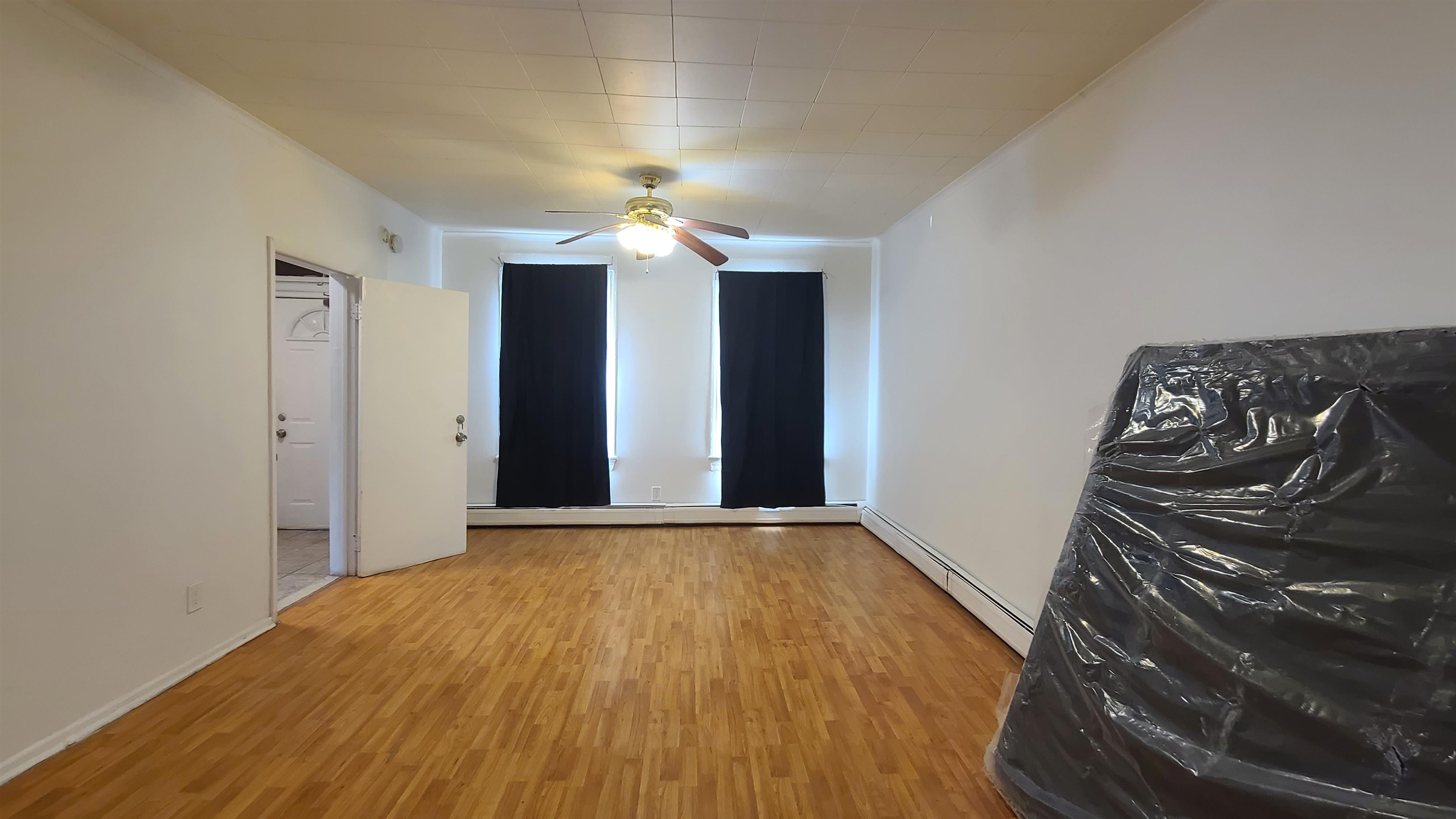 wooden floor in an empty room with a window