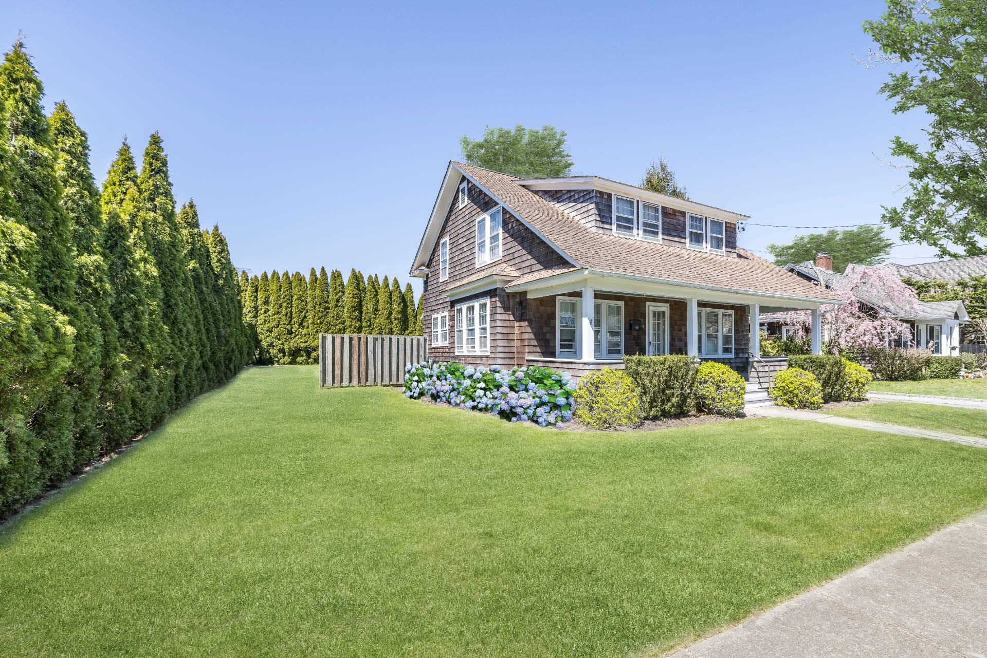 a front view of house with yard and green space