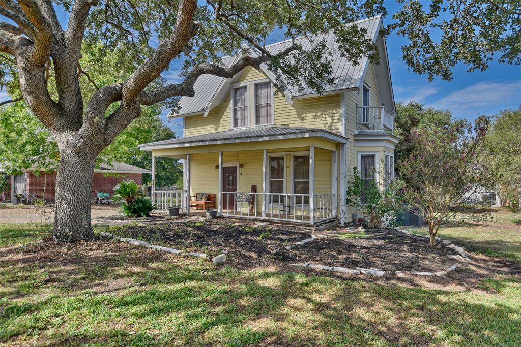 front view of a house with a tree in front