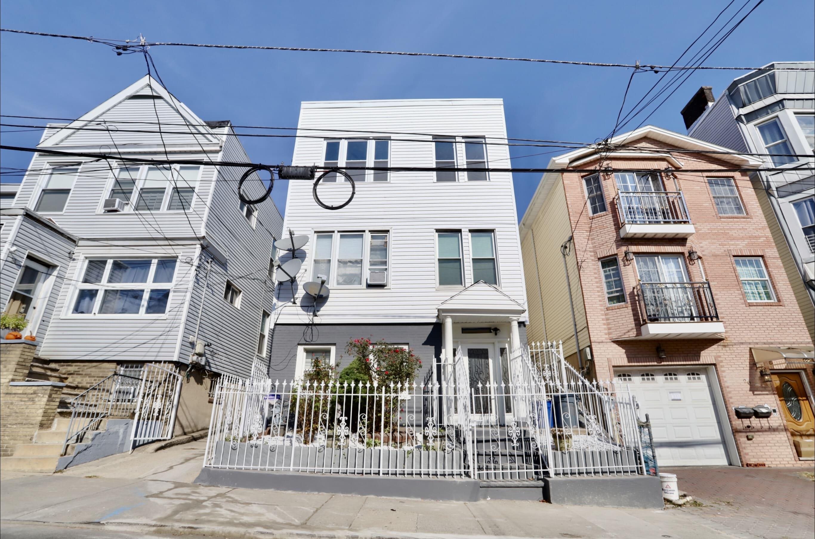 a front view of a residential apartment building with a yard