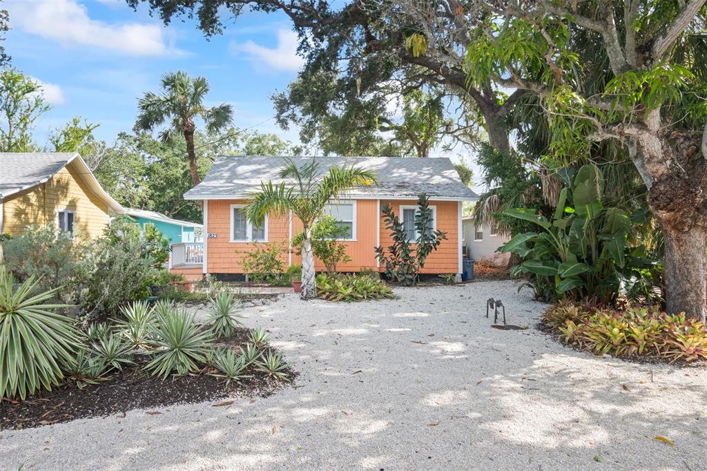 a view of a house with a tree in the background