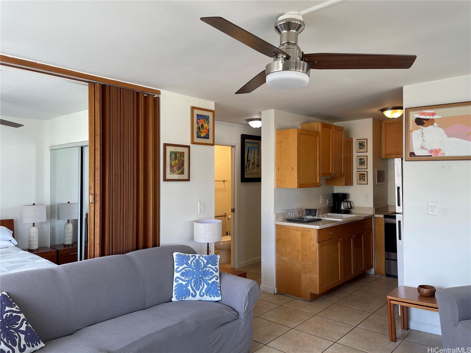 a living room with stainless steel appliances kitchen island granite countertop furniture and a view of kitchen