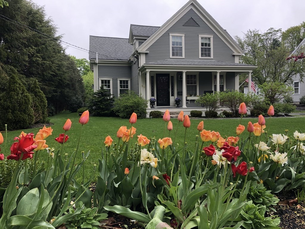 a front view of house with yard and outdoor seating