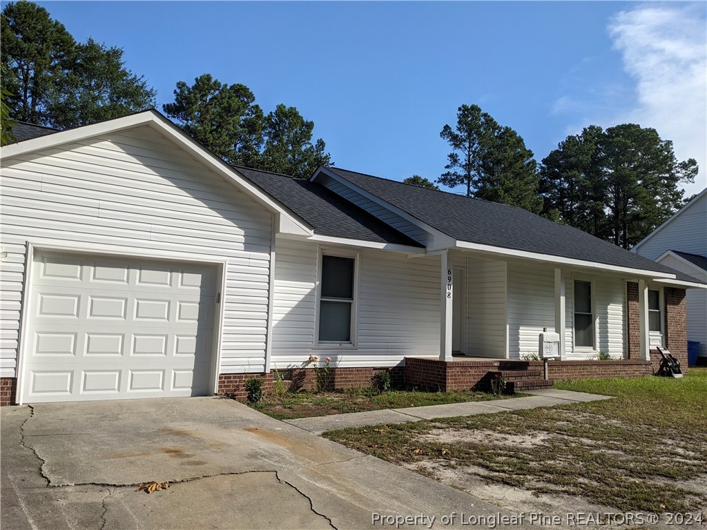 a view of a house with a yard and garage