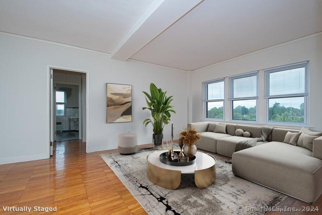 a living room with furniture and a wooden floor