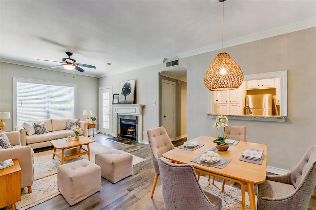 a living room with fireplace furniture and a chandelier