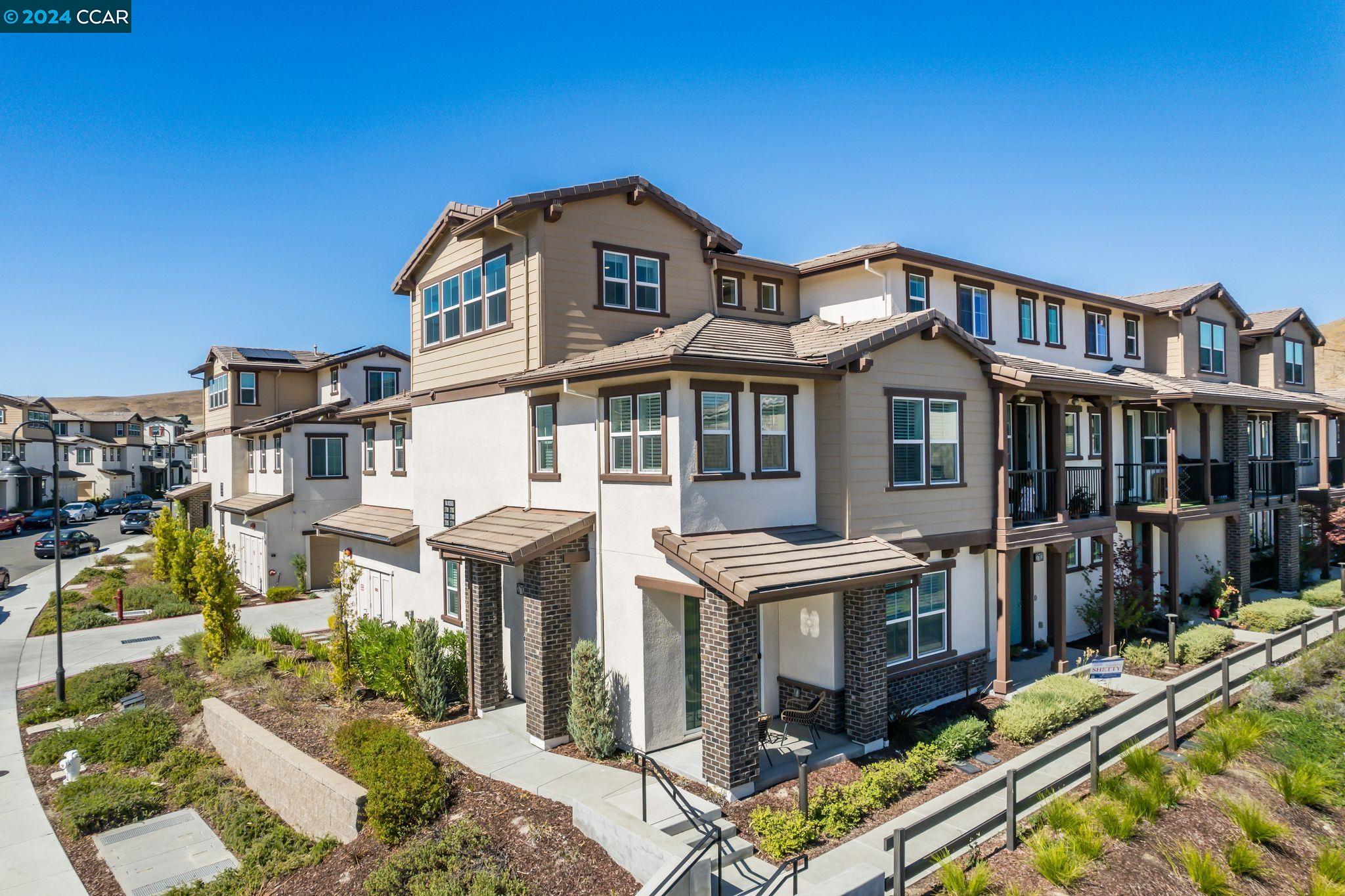 a front view of a residential apartment building with a yard