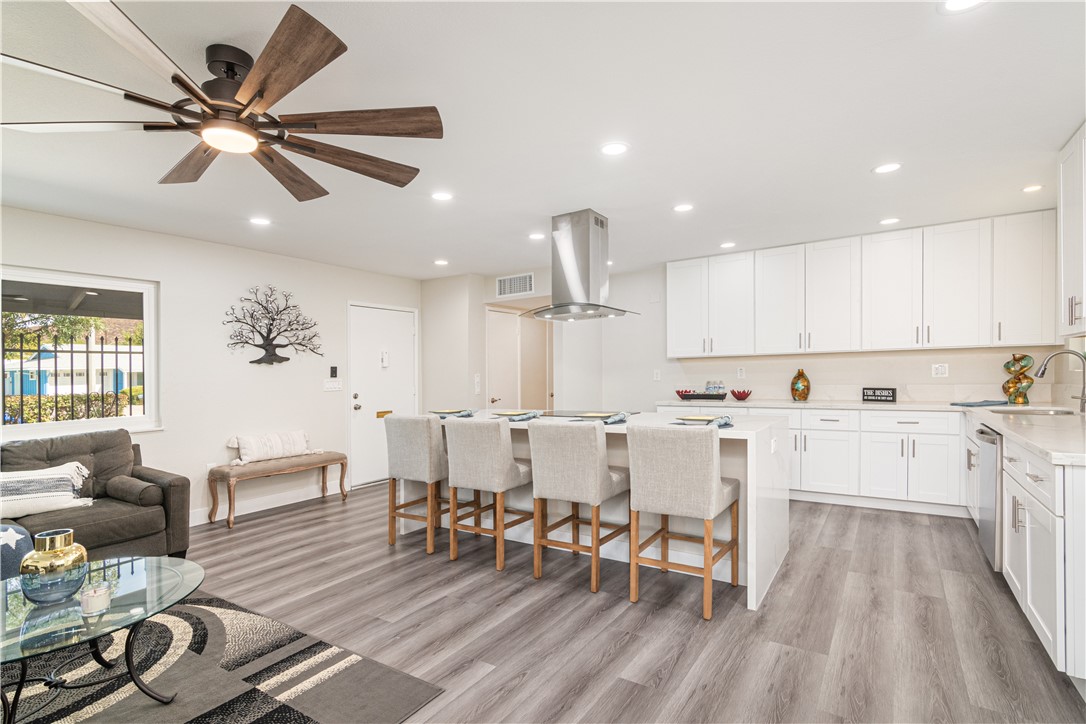 a large kitchen with cabinets table and chairs