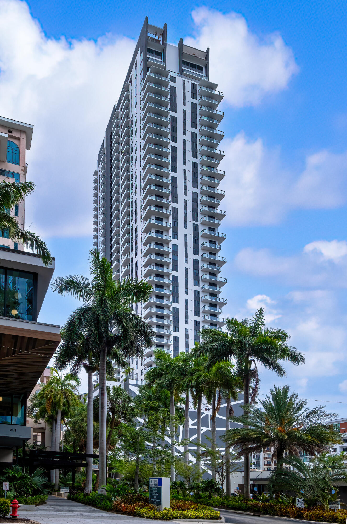 a view of a tall building with a yard in front of it