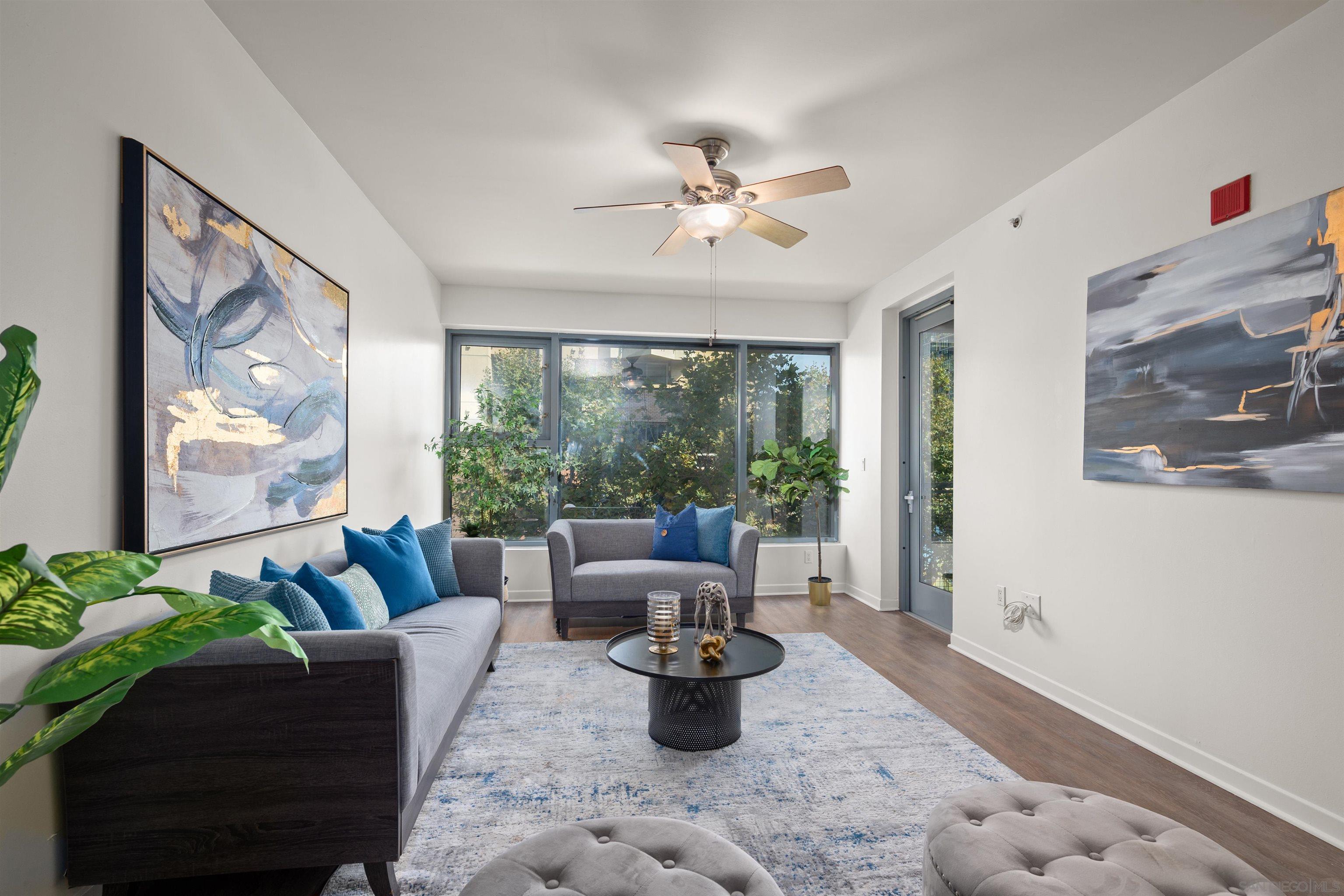 a living room with furniture and a large window