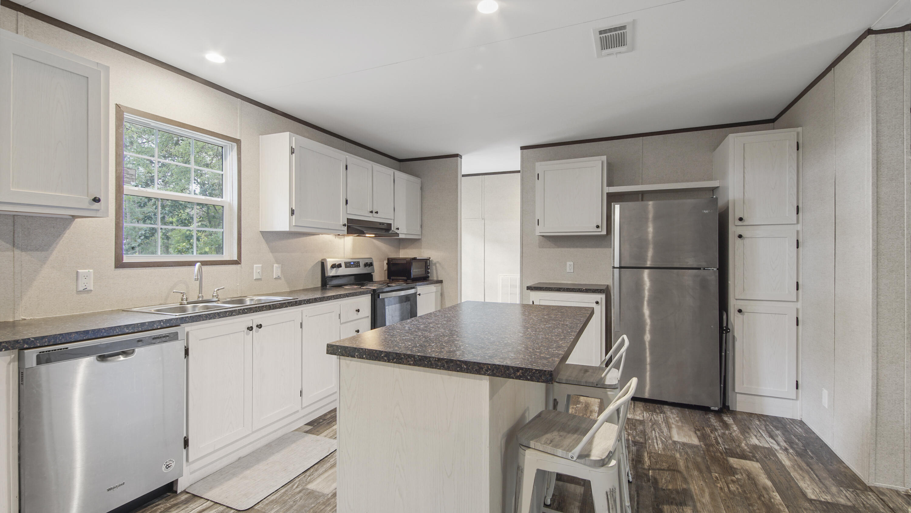 a kitchen with stainless steel appliances granite countertop a refrigerator sink and stove