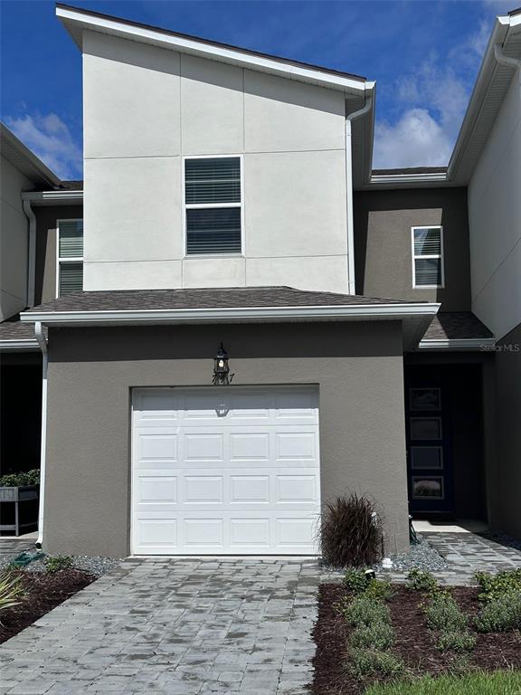 a front view of house with garage