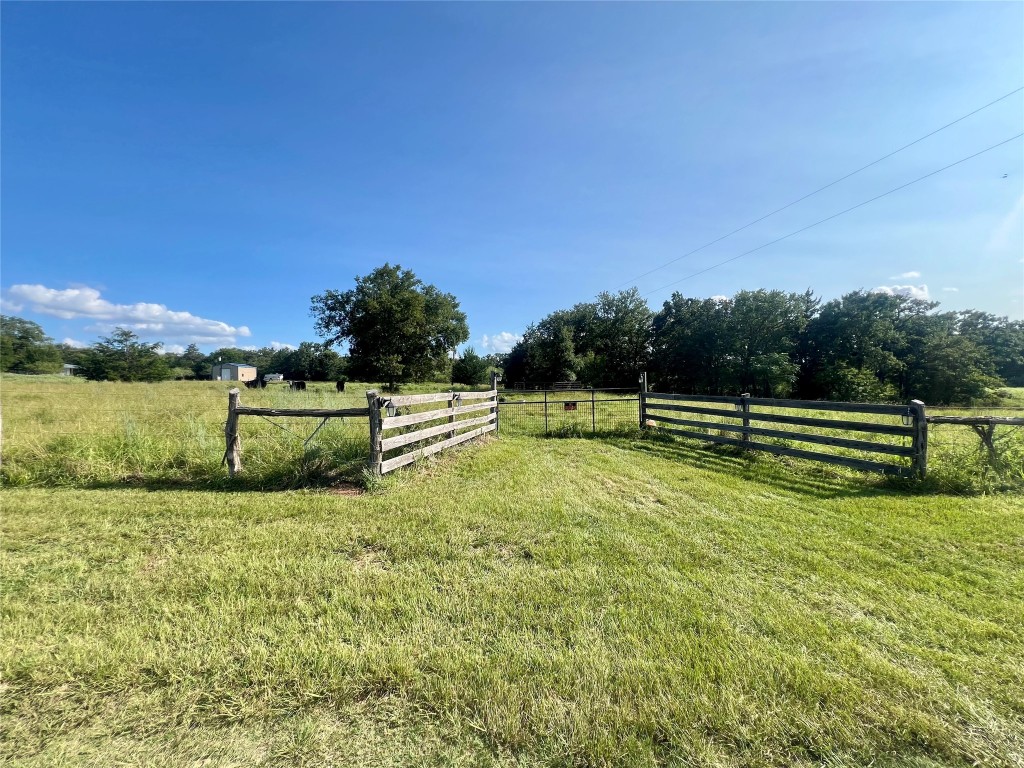 a view of a golf course with a wooden fence