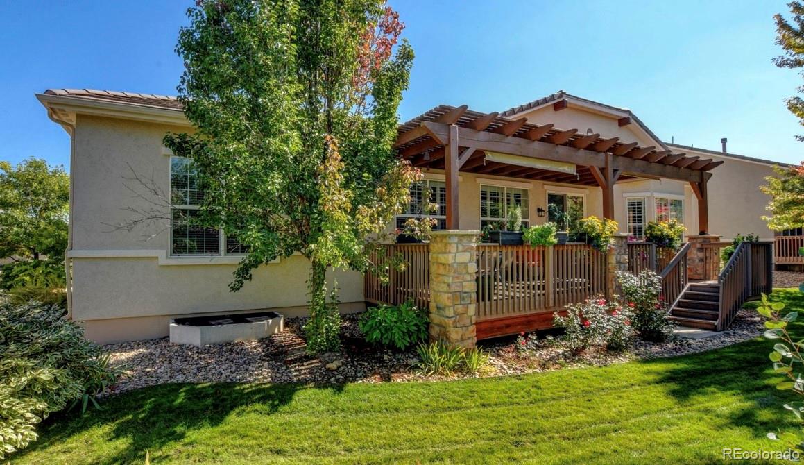 a view of a house with a yard and potted plants