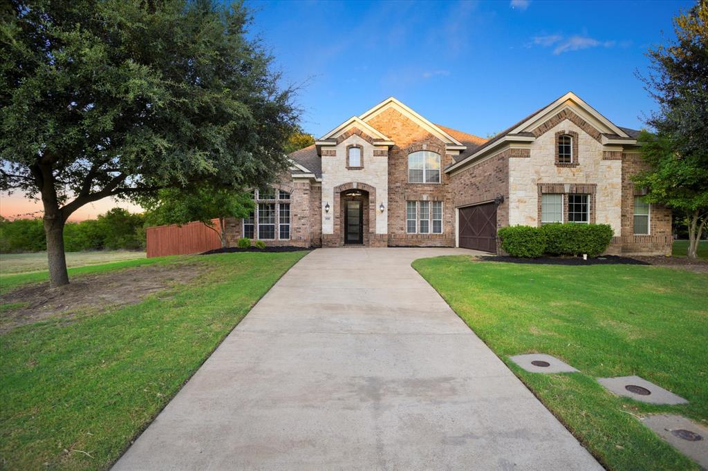 a front view of a house with a yard and garage