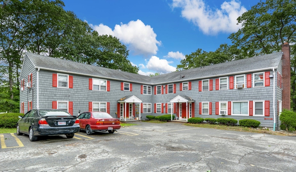 a front view of a residential apartment building with a yard