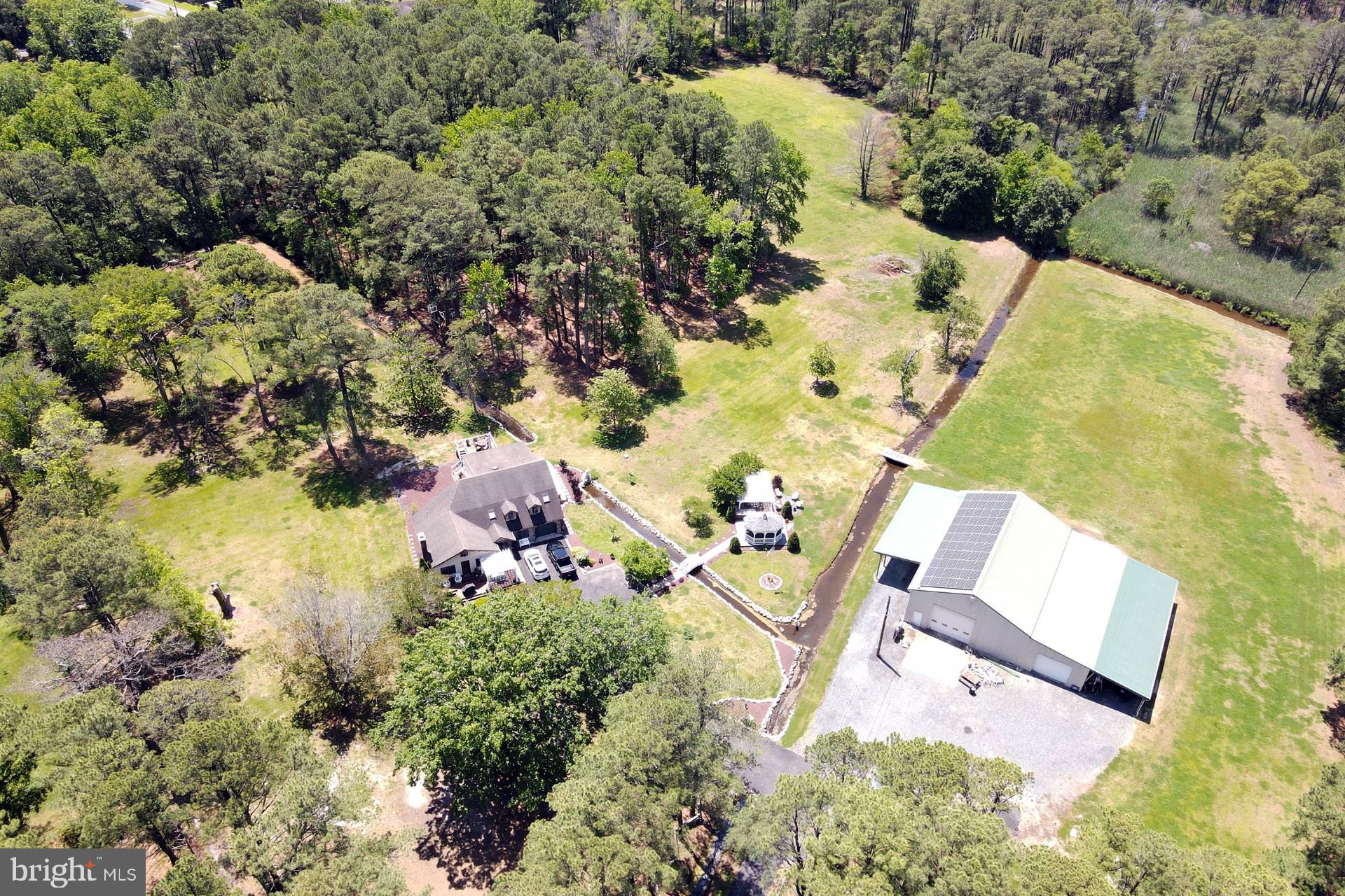 an aerial view of a house with a yard and lake view