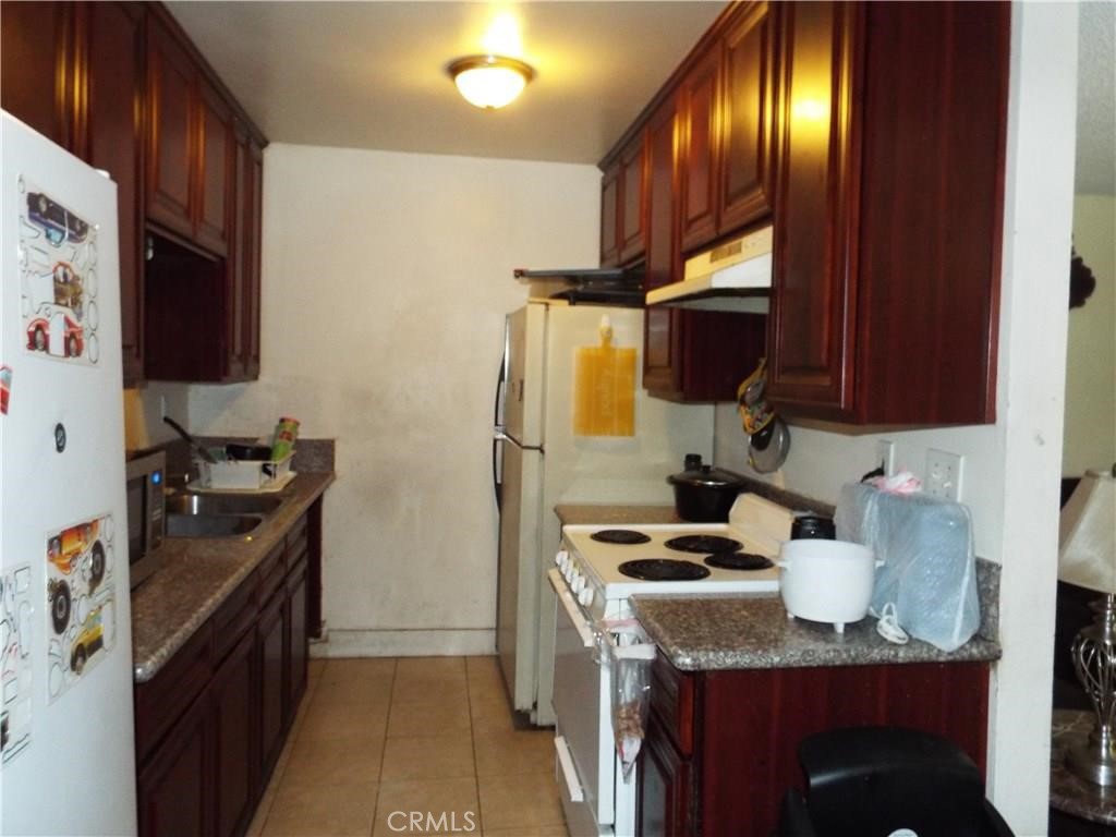 a kitchen with a sink stove and refrigerator