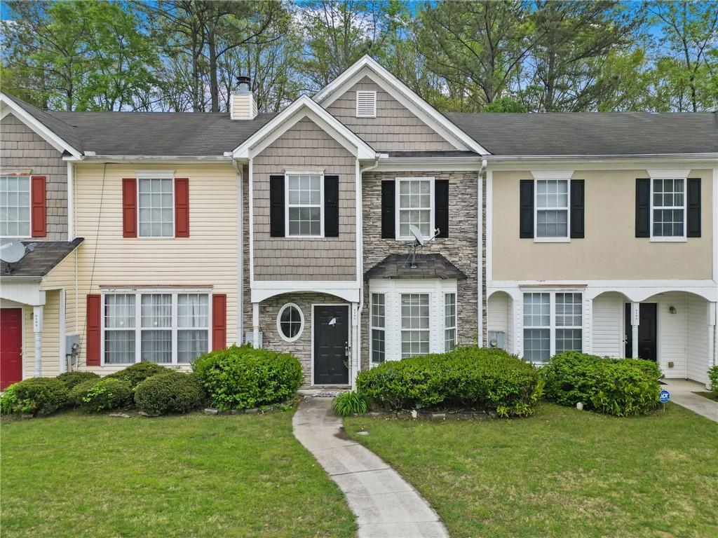 a front view of a house with a yard