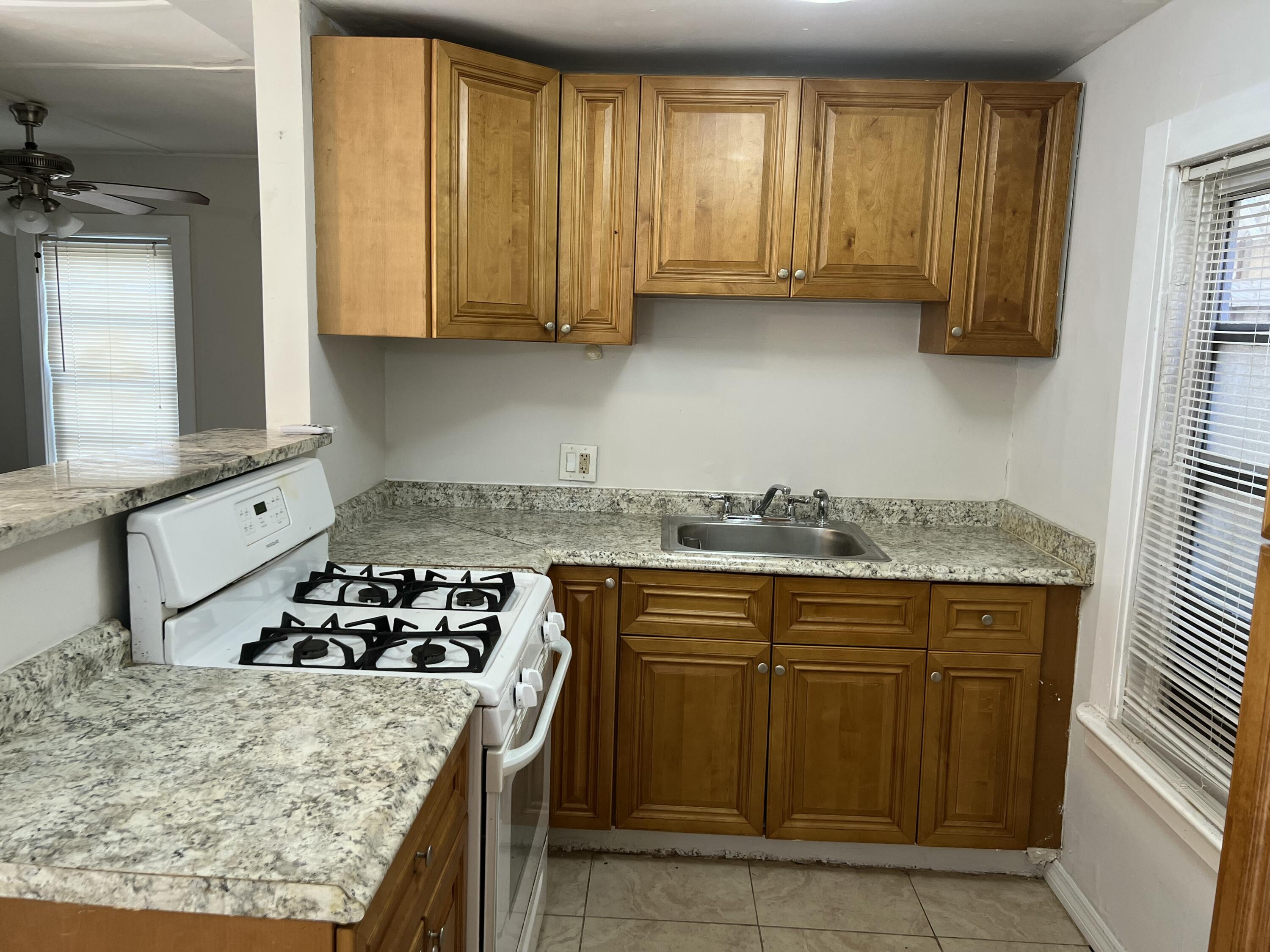 Kitchen wood cabinets & gas stove