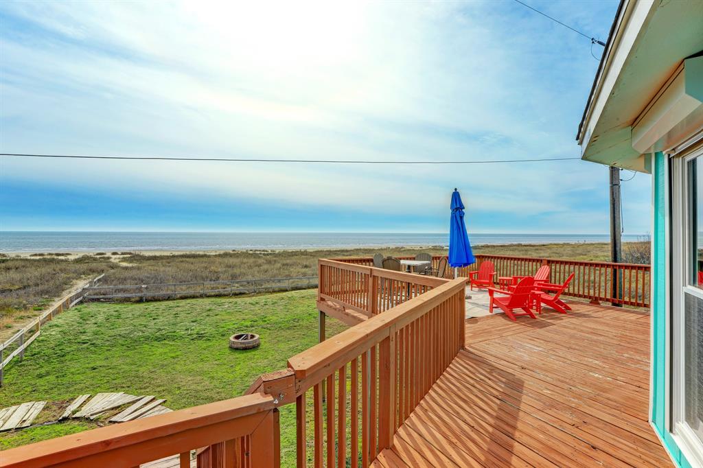 a view of a balcony with yard