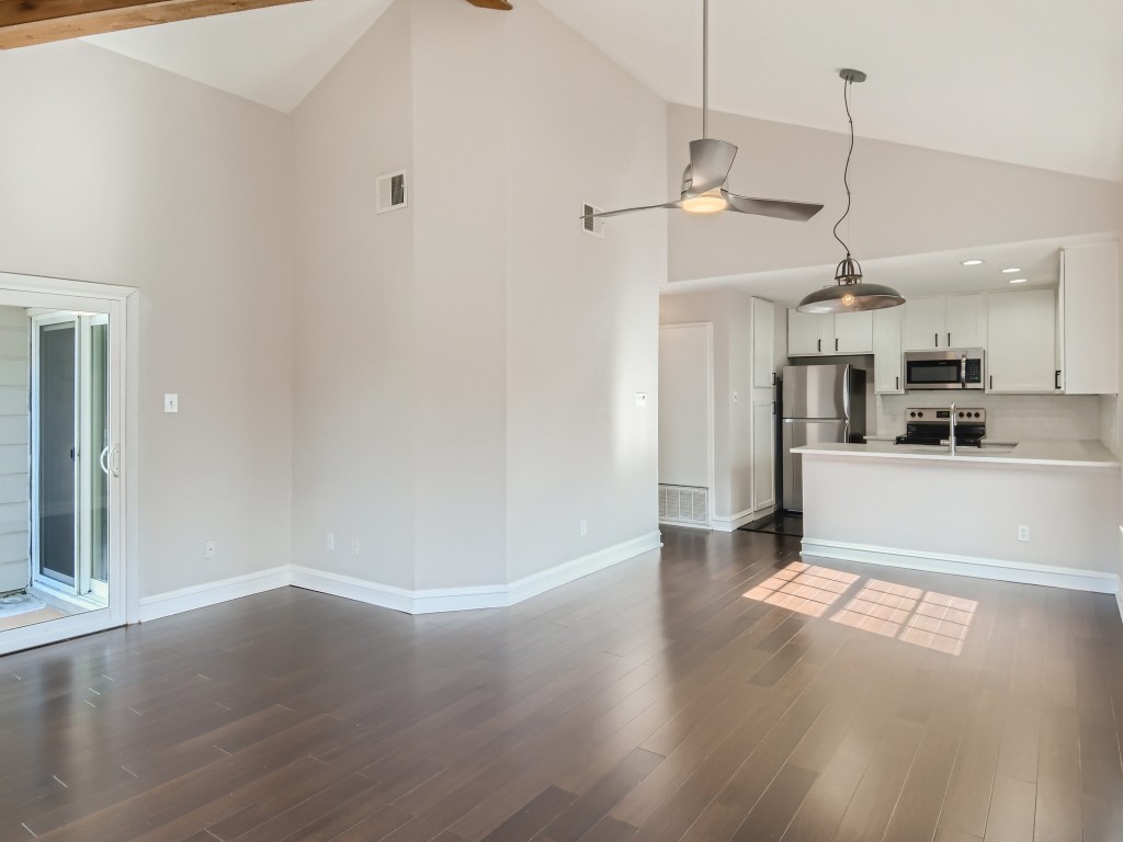 a view of a kitchen with wooden floor and a window